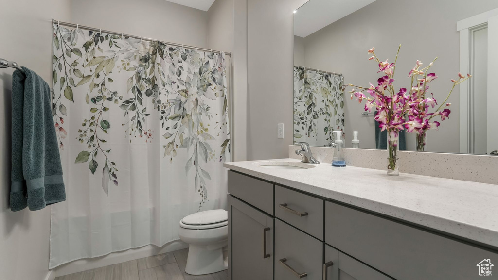 Bathroom featuring vanity, toilet, and shower / bath combo