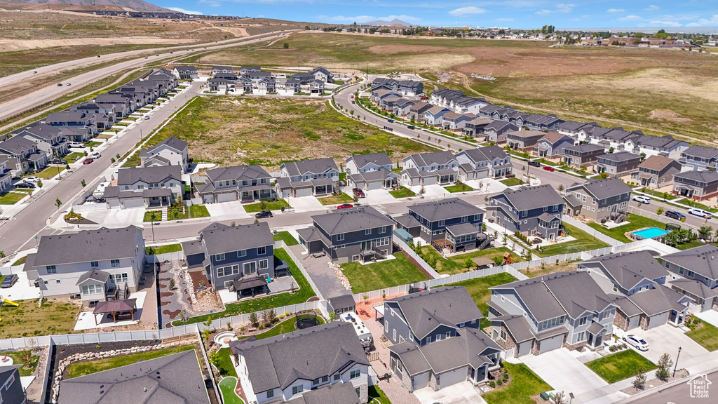 Aerial view of property and surrounding area featuring nearby suburban area