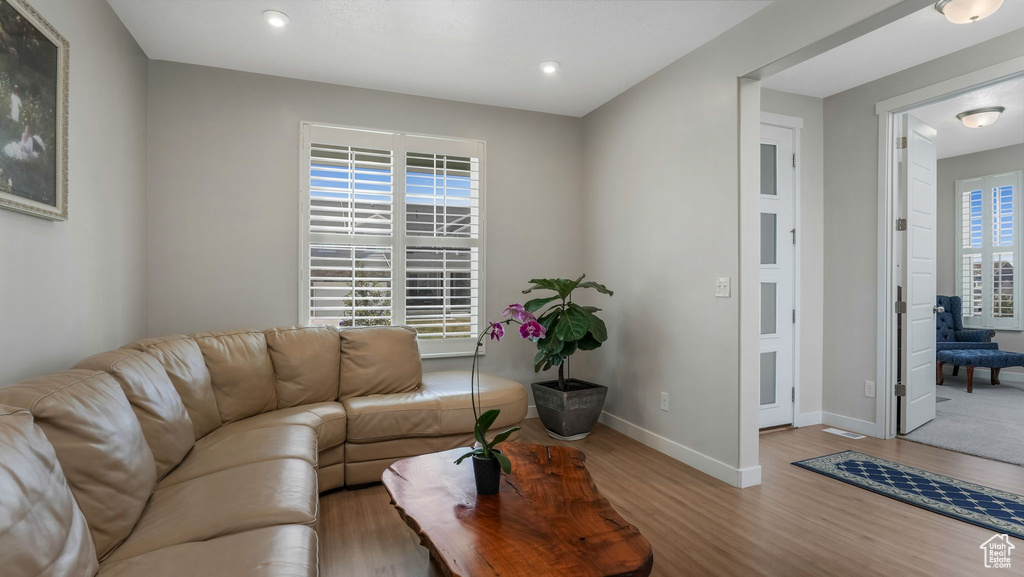 Living area featuring wood finished floors, baseboards, and recessed lighting