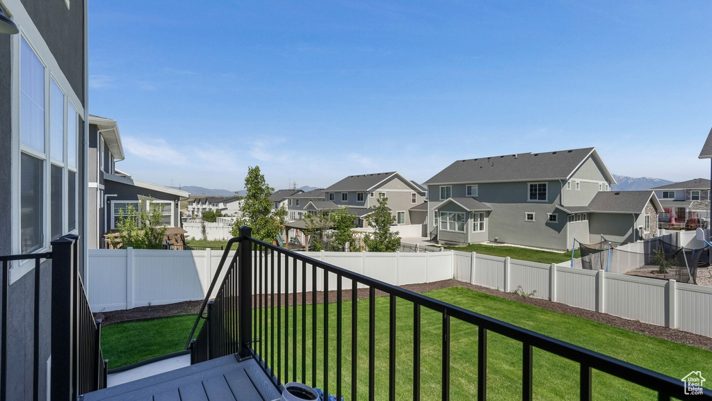 Balcony featuring a residential view and a mountain view