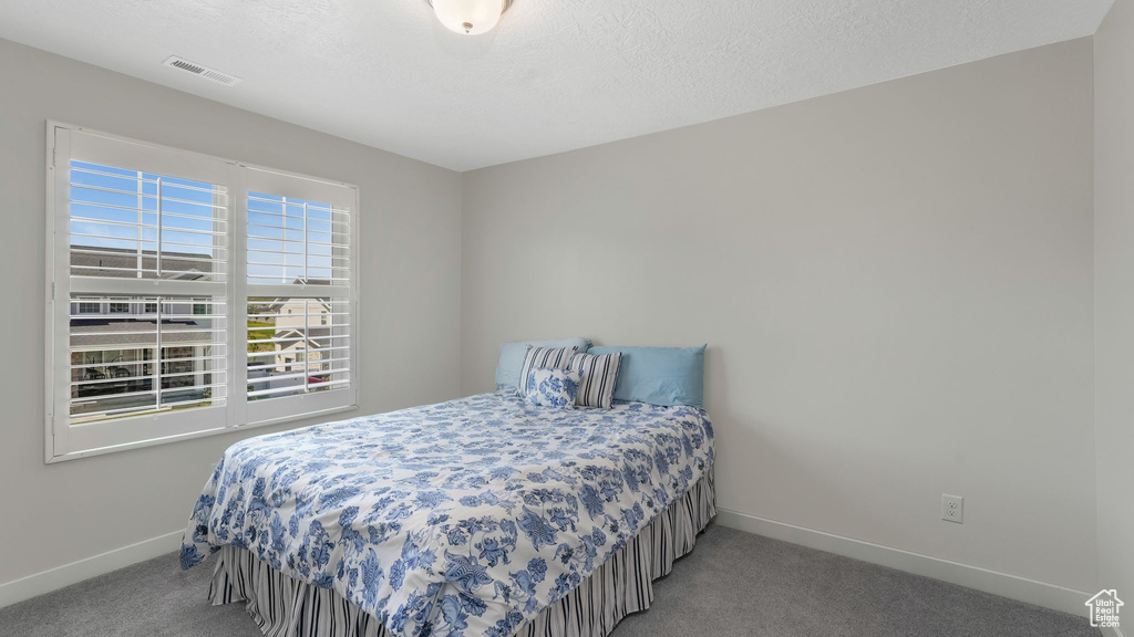 Bedroom with carpet flooring and baseboards