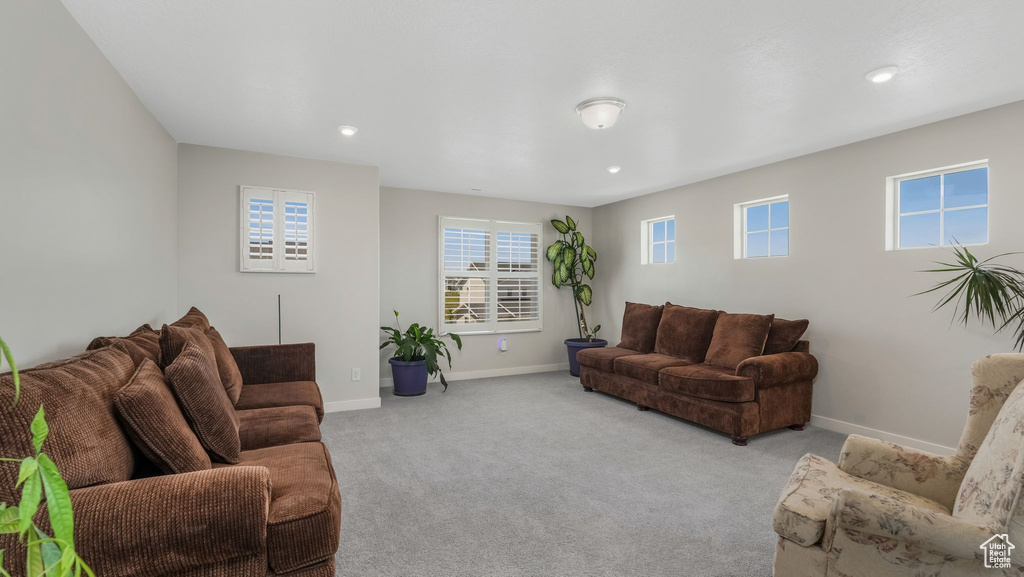 Living room featuring carpet flooring, baseboards, and recessed lighting