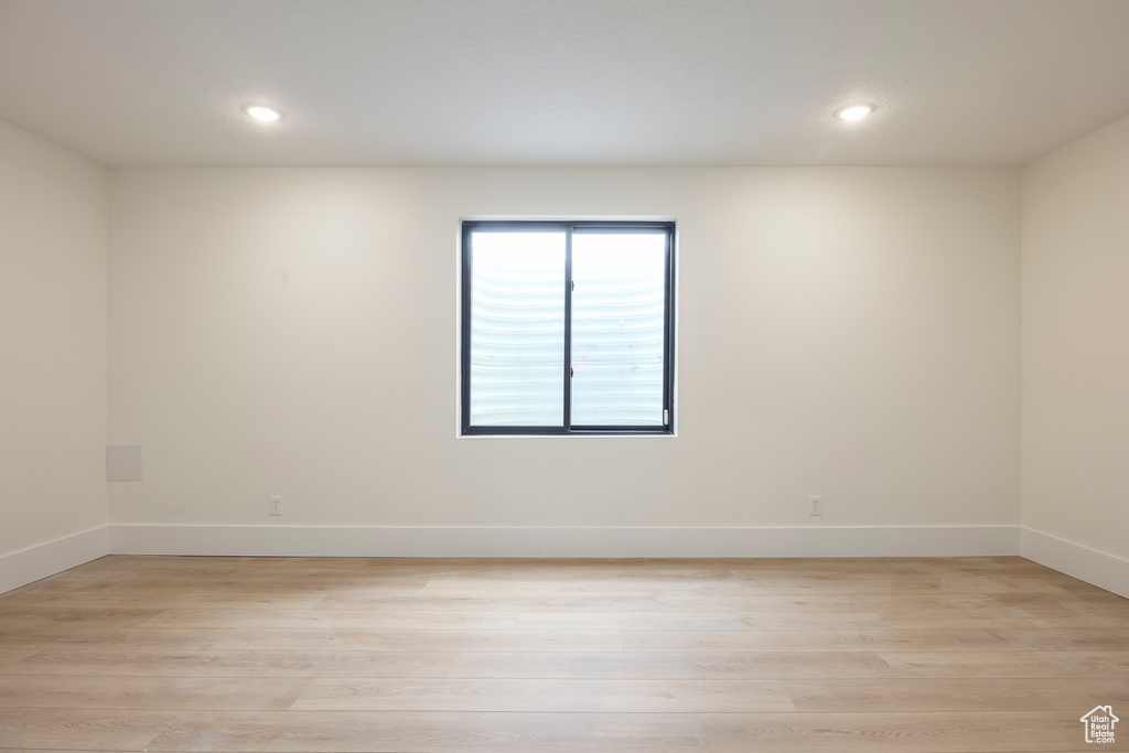 Unfurnished room with recessed lighting, baseboards, and light wood-type flooring