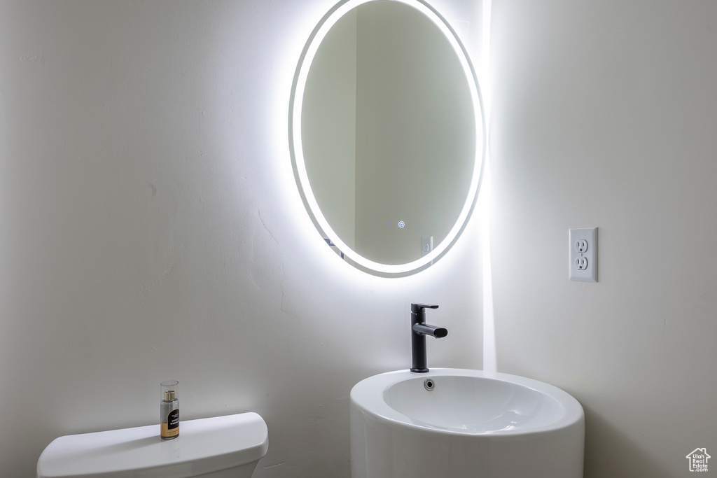 Half bath featuring toilet and a sink