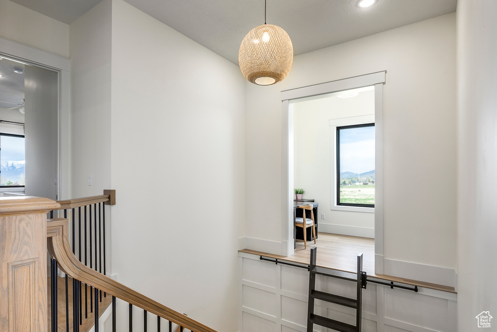 Corridor featuring a wealth of natural light, an upstairs landing, and recessed lighting