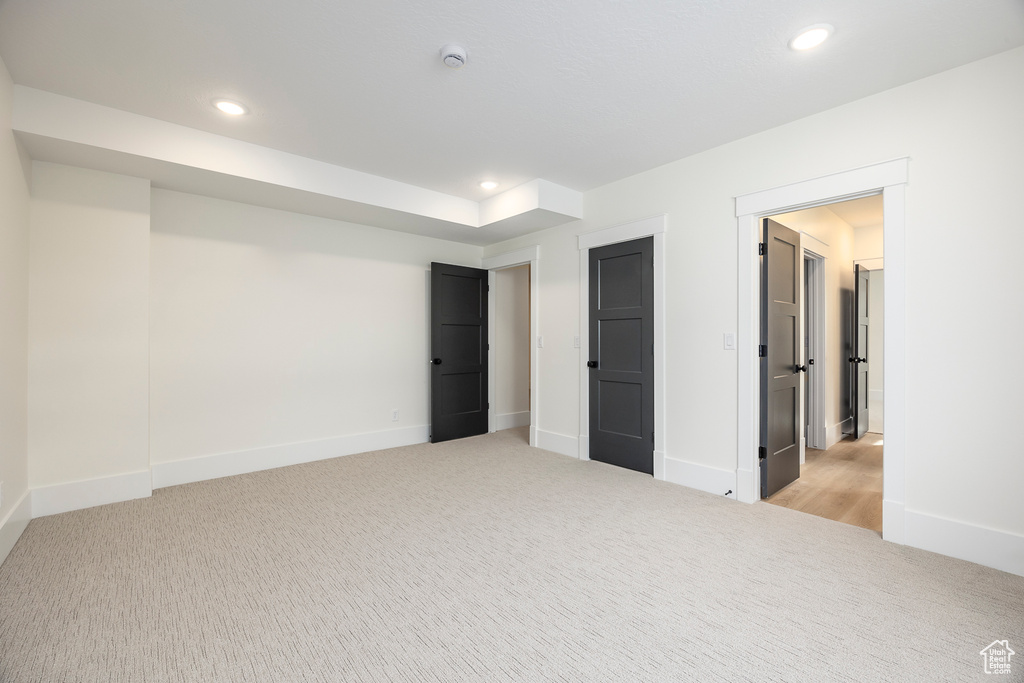 Unfurnished bedroom with baseboards, light carpet, and recessed lighting