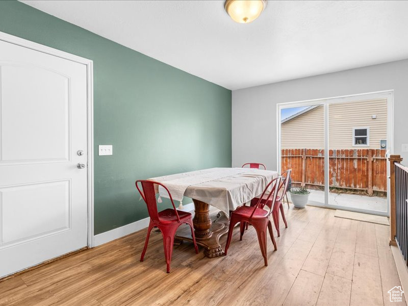 Dining area with light wood-type flooring and baseboards