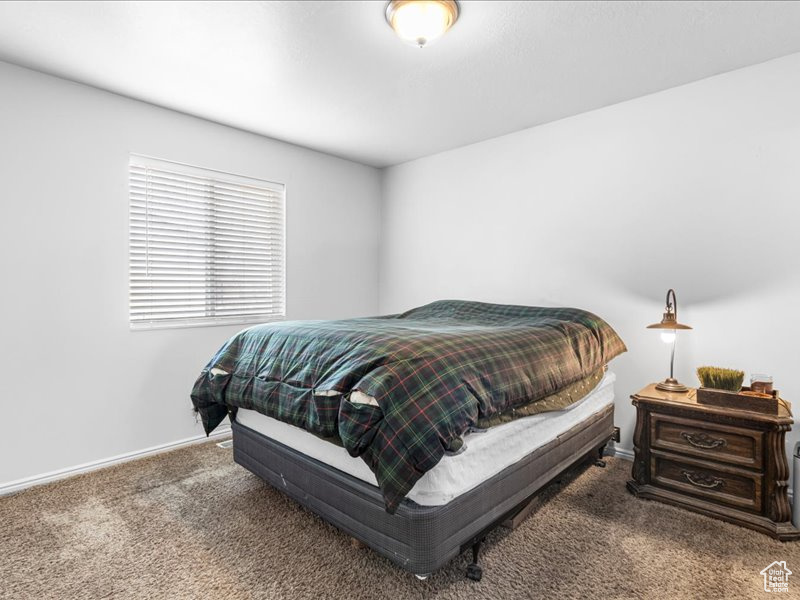 Carpeted bedroom featuring baseboards