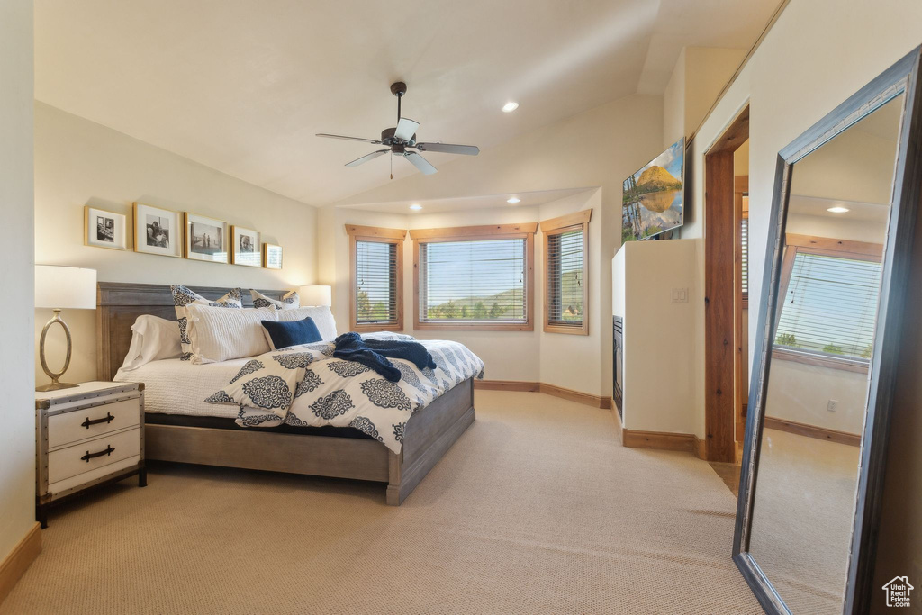 Bedroom with light carpet, multiple windows, recessed lighting, baseboards, and vaulted ceiling