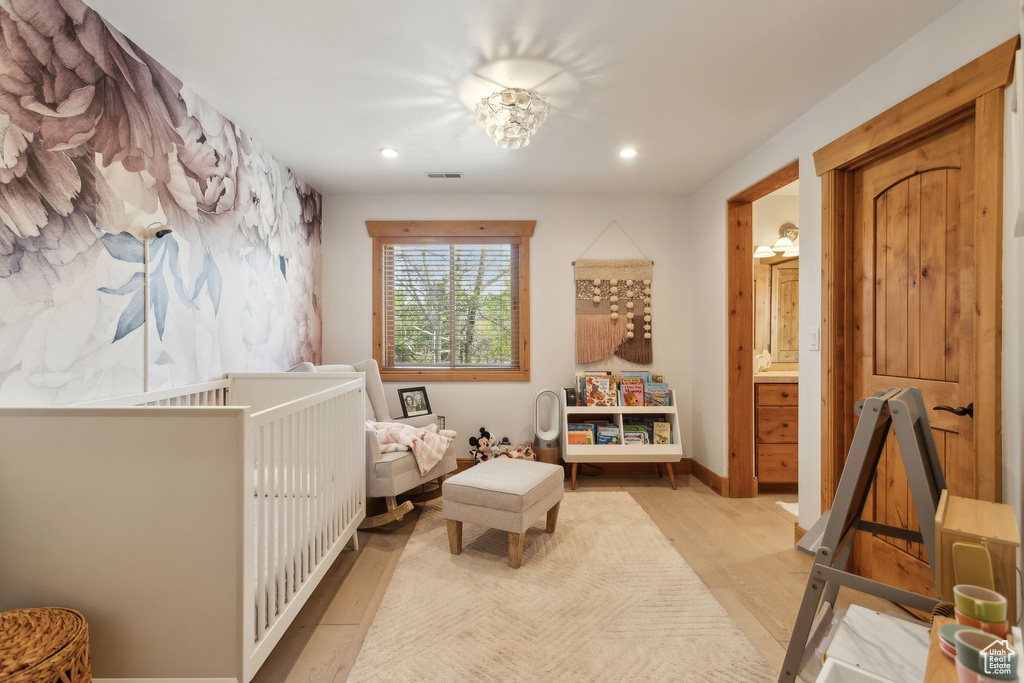 Bedroom with wood finished floors and recessed lighting