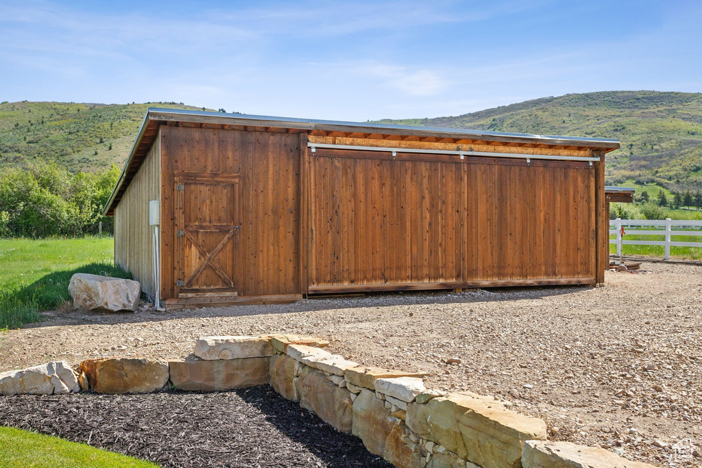 View of outbuilding with a mountain view