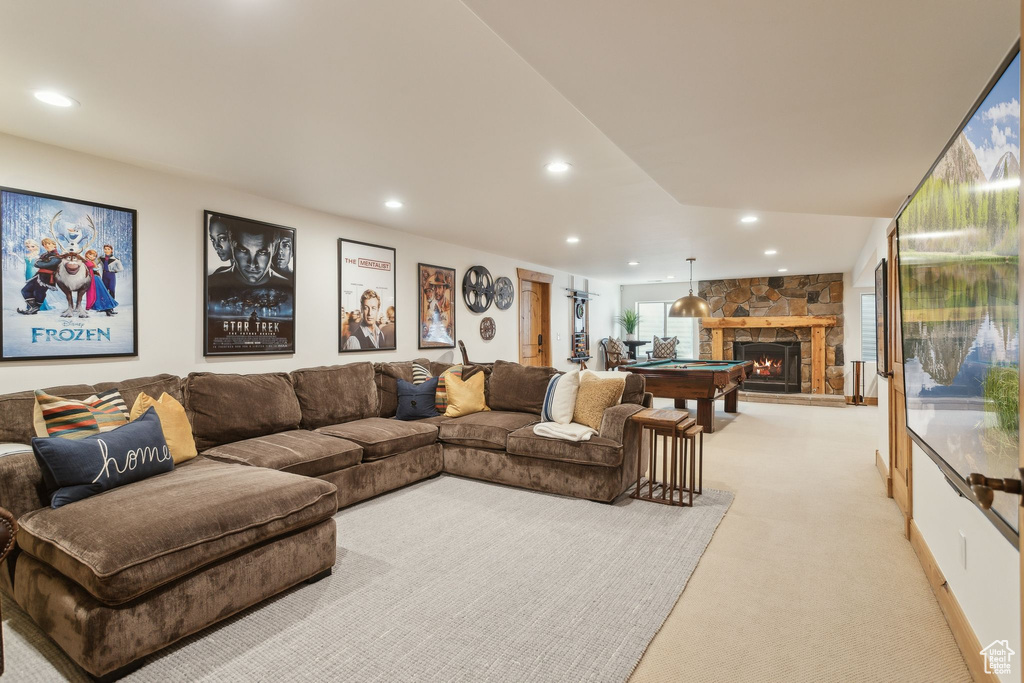 Living room featuring light carpet, recessed lighting, a fireplace, and billiards table