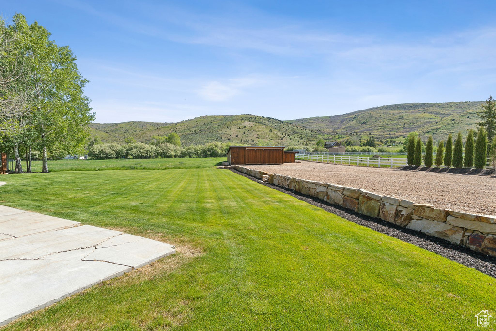View of yard featuring a mountain view, a view of countryside, and an outbuilding