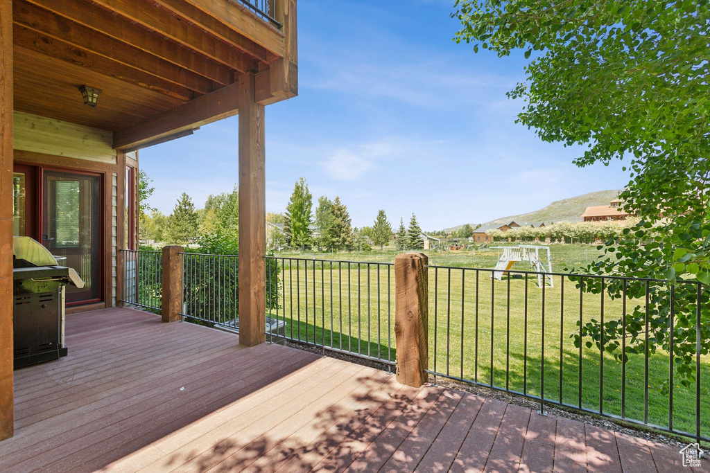 Deck featuring a yard and a mountain view
