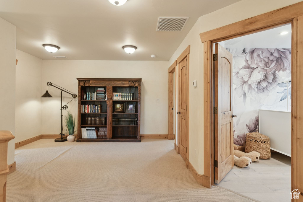 Hall featuring carpet flooring and baseboards