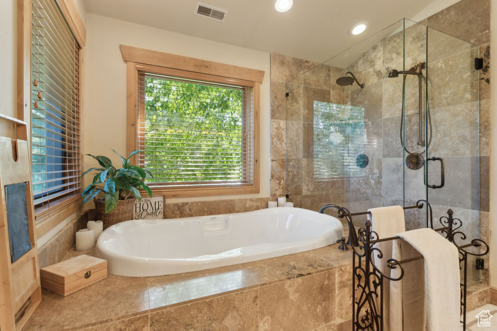 Full bathroom with a bath, a shower stall, and recessed lighting