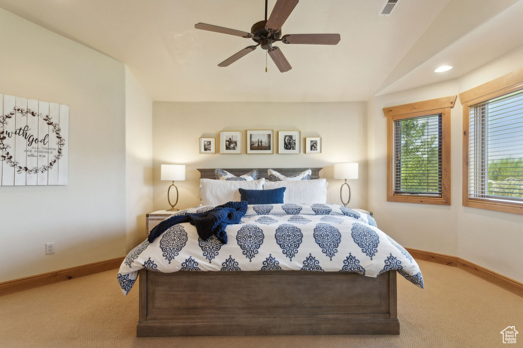 Bedroom with carpet floors, baseboards, lofted ceiling, and ceiling fan