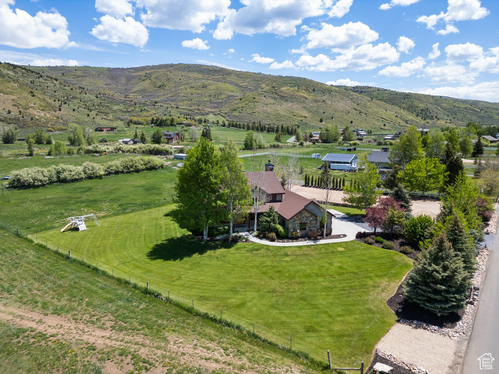 View of rural area with a mountain backdrop and agricultural land