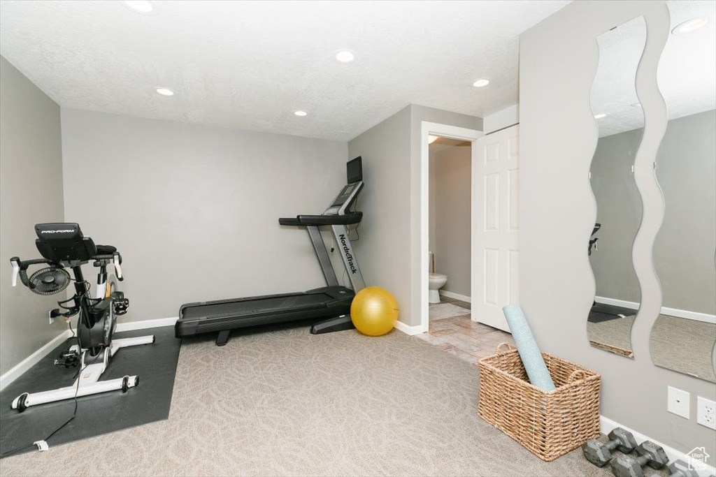 Workout area with baseboards and recessed lighting