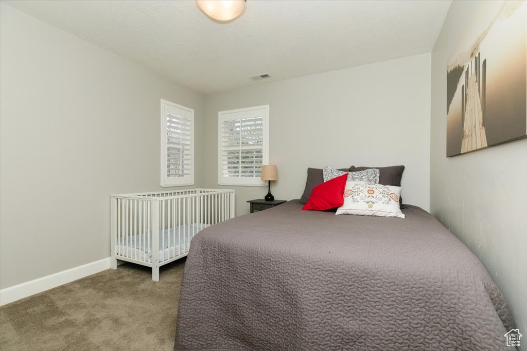 Carpeted bedroom with visible vents