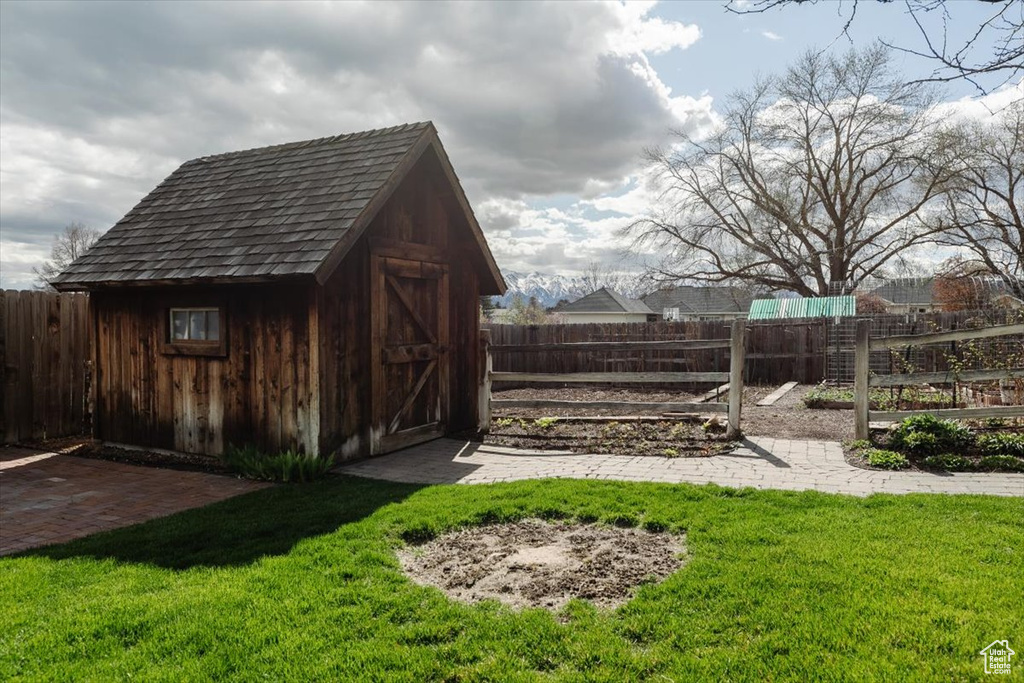 View of shed featuring fence
