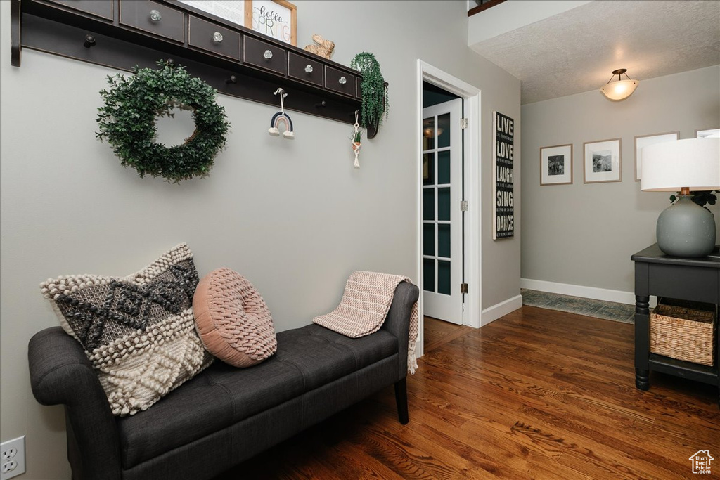 Living area featuring baseboards and wood finished floors