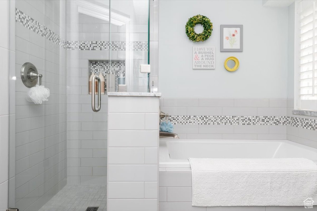 Bathroom featuring a shower stall and a garden tub