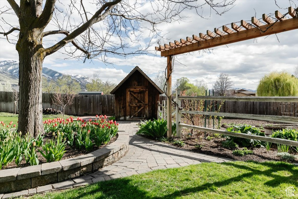 View of yard featuring a fenced backyard, an outbuilding, and a storage unit