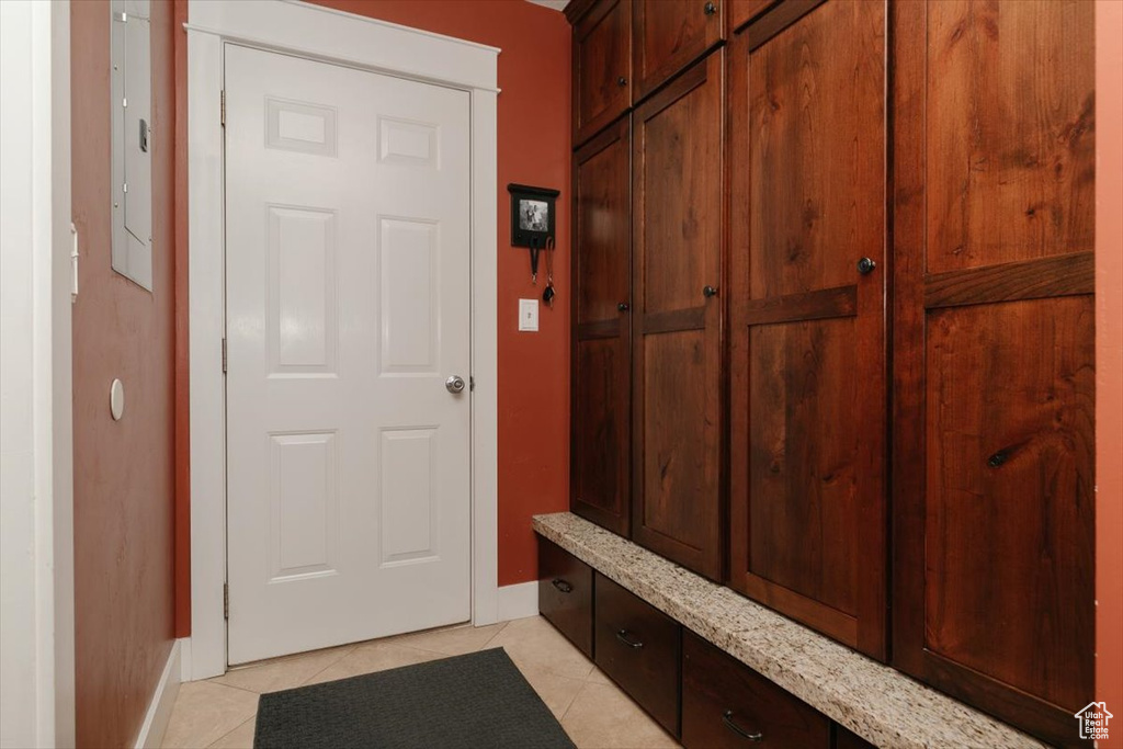 Mudroom with baseboards and light tile patterned flooring