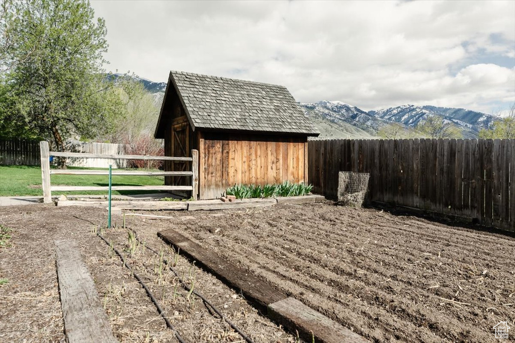 Exterior space with a fenced backyard and a mountain view