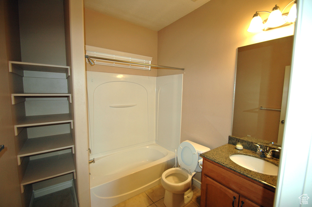 Full bath featuring tile patterned flooring, bathing tub / shower combination, toilet, and vanity
