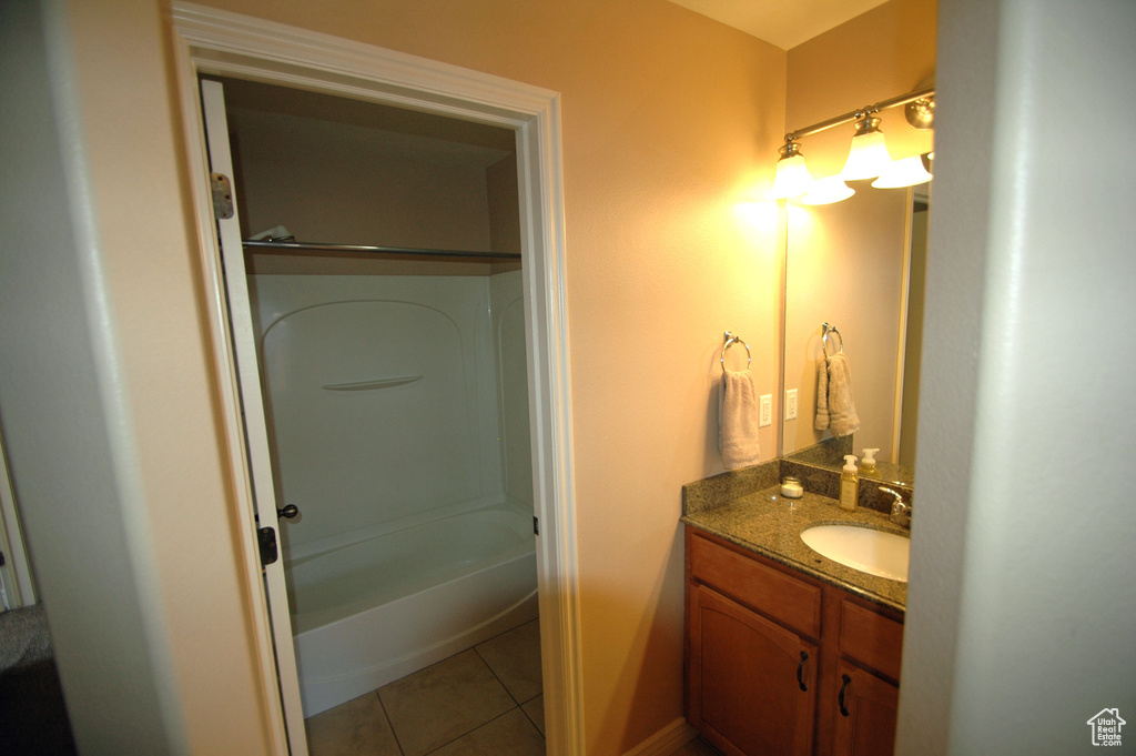 Full bathroom with vanity, tile patterned flooring, and bathing tub / shower combination