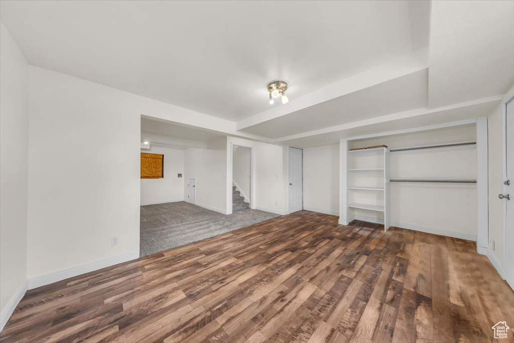 Interior space featuring wood finished floors, built in features, baseboards, and stairway
