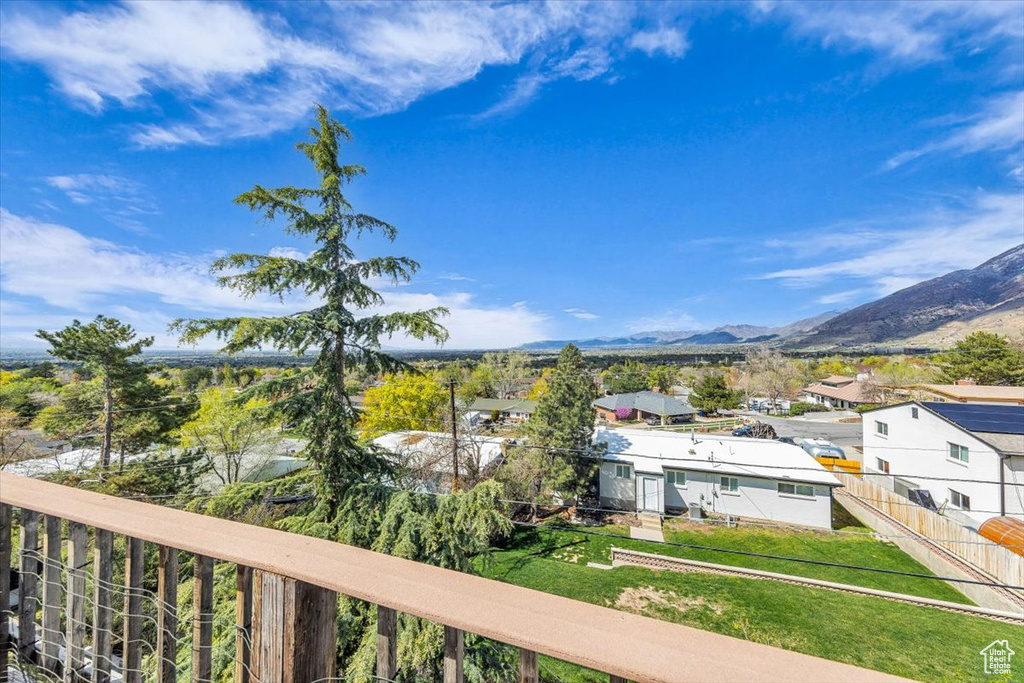 Balcony featuring a residential view and a mountain view