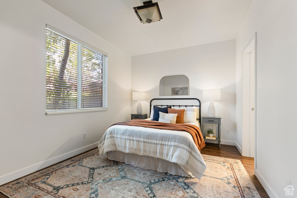 Bedroom featuring baseboards and wood finished floors