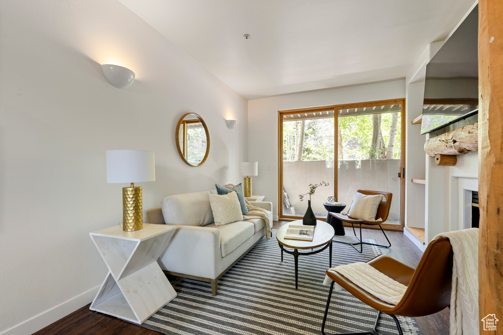 Living area with wood finished floors and baseboards