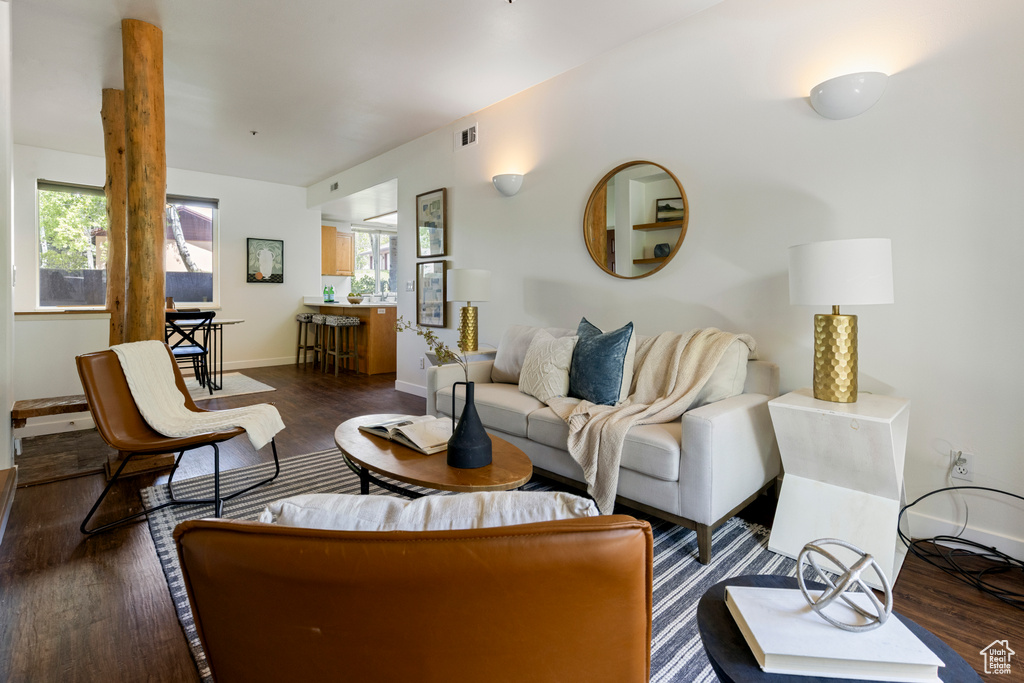 Living area with healthy amount of natural light, dark wood finished floors, and baseboards