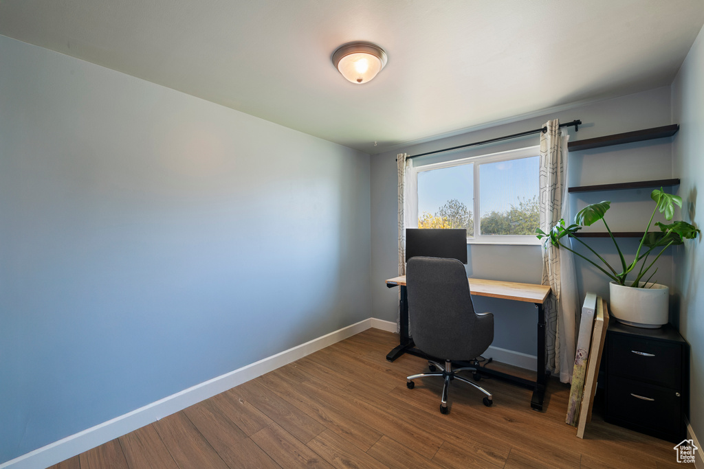Office featuring wood finished floors and baseboards