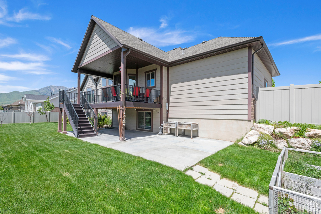 Back of property featuring a patio, stairway, and a mountain view