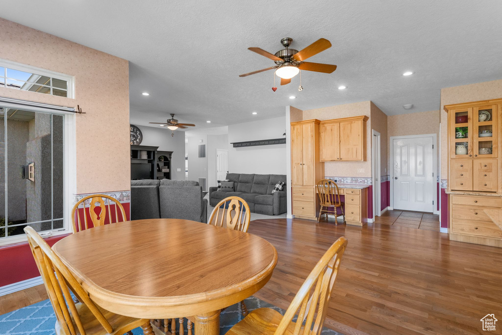 Dining space featuring recessed lighting, wood finished floors, a ceiling fan, and baseboards