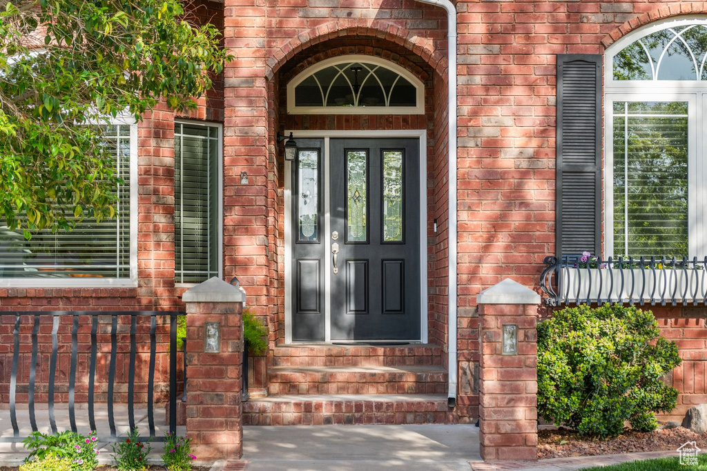 Doorway to property featuring brick siding