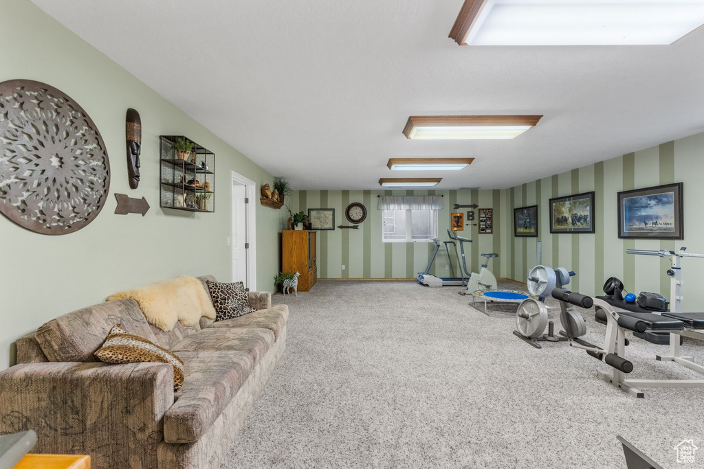Living room with wallpapered walls and carpet floors