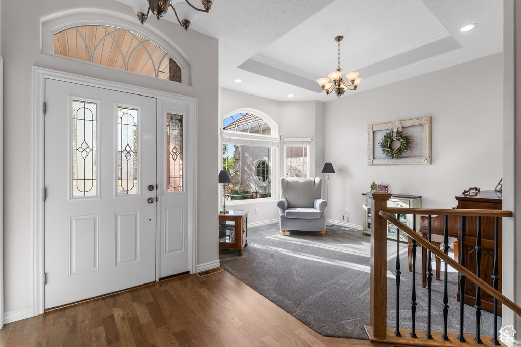 Entryway featuring wood finished floors, baseboards, recessed lighting, and a chandelier
