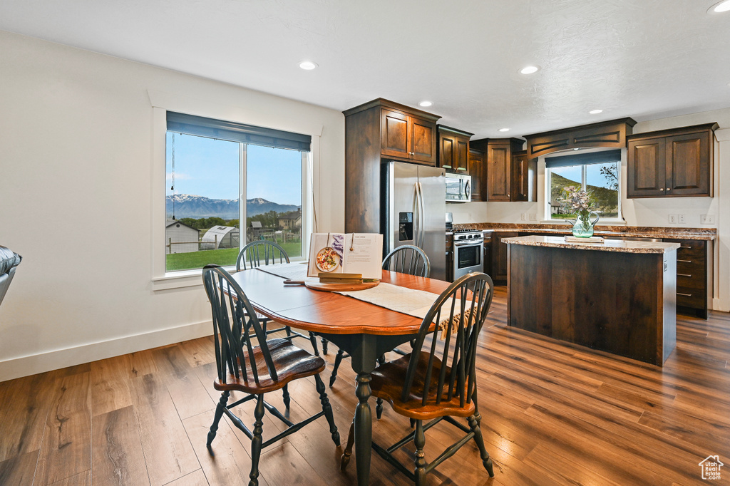 Dining area with recessed lighting, baseboards, a mountain view, and dark wood-style flooring