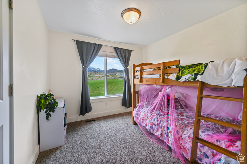 Bedroom with baseboards, carpet flooring, a mountain view, and visible vents
