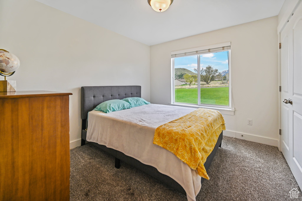 Bedroom with baseboards and carpet