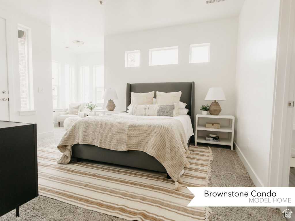 Bedroom with carpet floors, visible vents, and baseboards