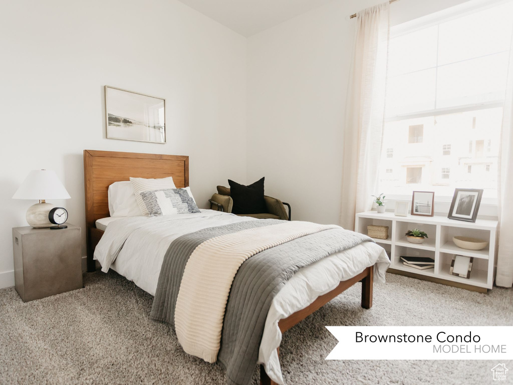 Bedroom featuring light carpet