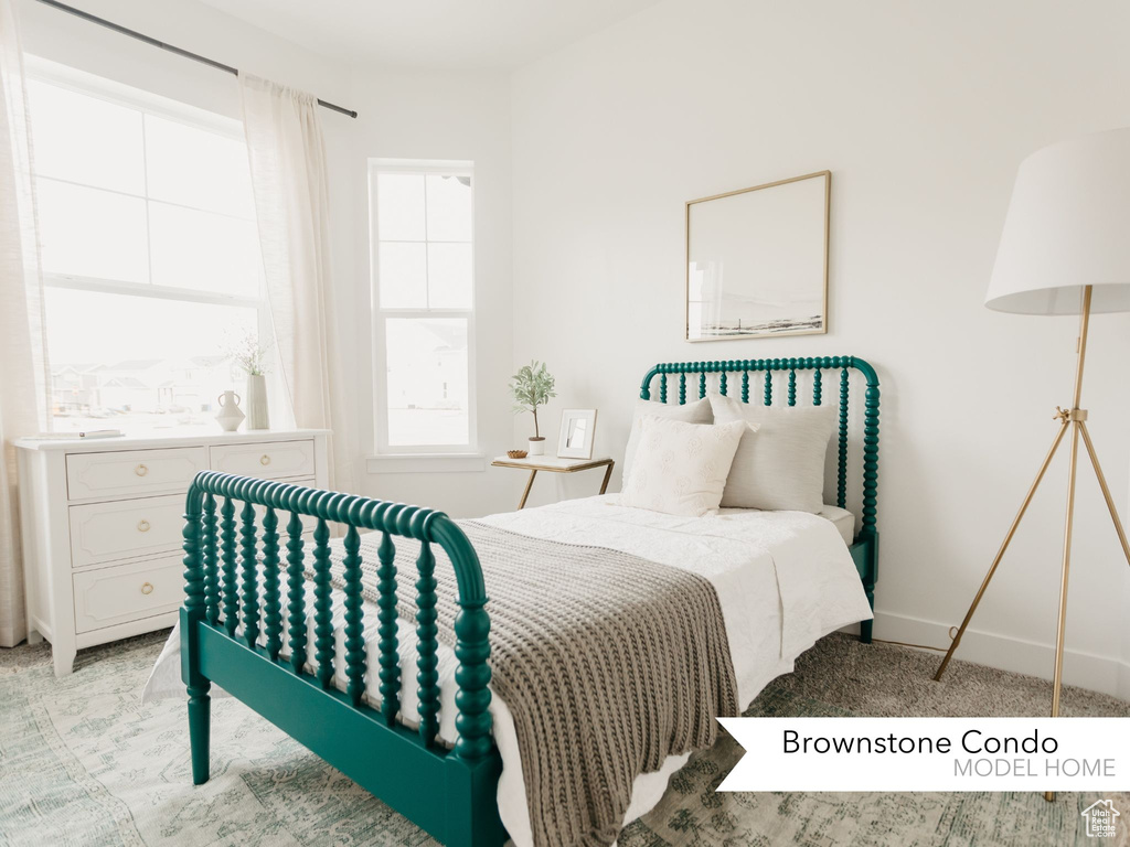 Bedroom with baseboards and light carpet