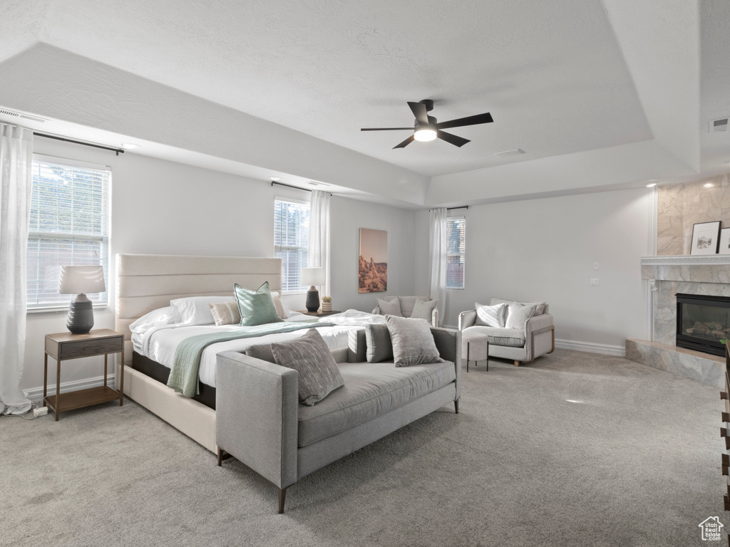 Bedroom featuring visible vents, a premium fireplace, baseboards, and carpet flooring